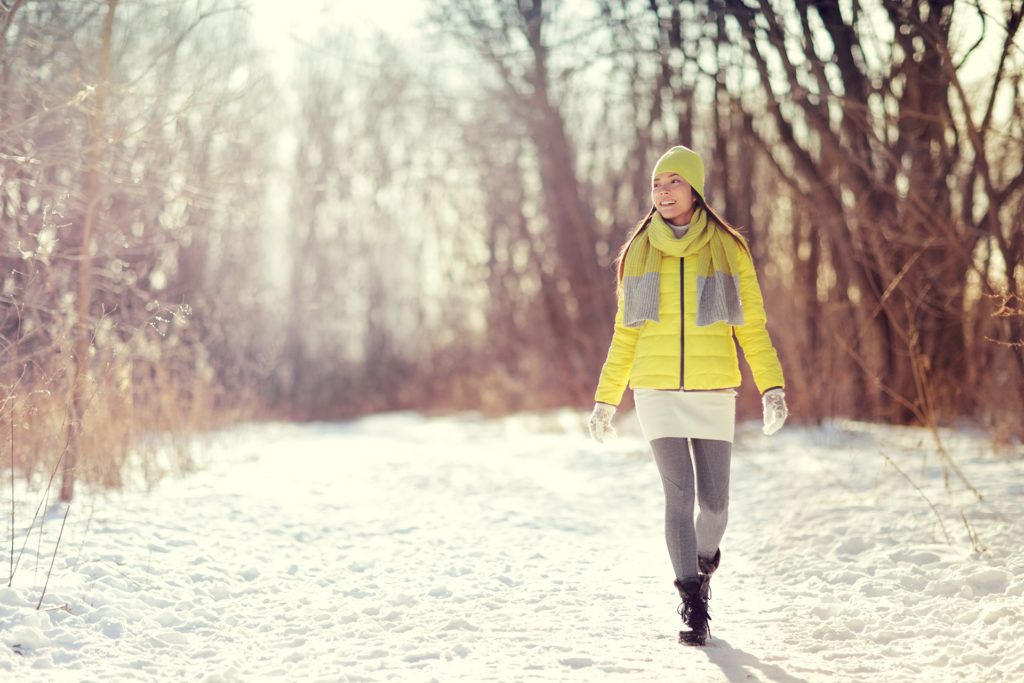 Woman walking in snow in park