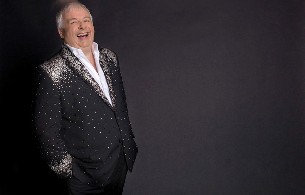 Christopher Biggins in a black and silver suit