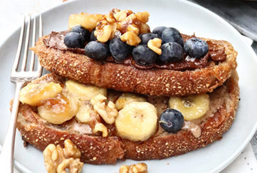 Vegan french toast topped with banana and blueberries