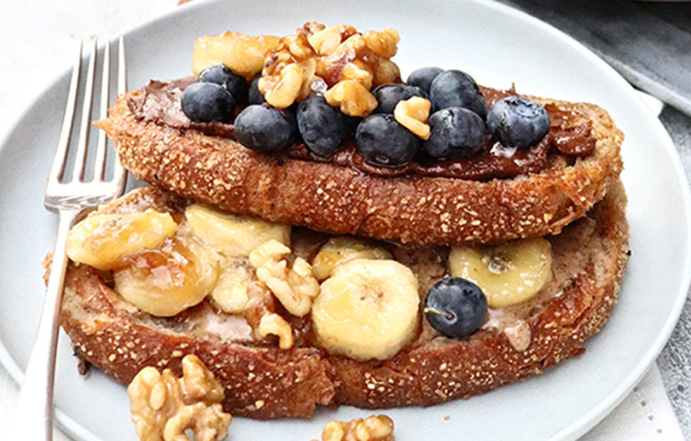 Vegan french toast topped with banana and blueberries