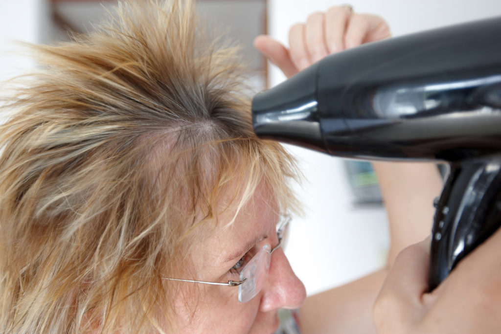 Woman using hairdryer motion blur