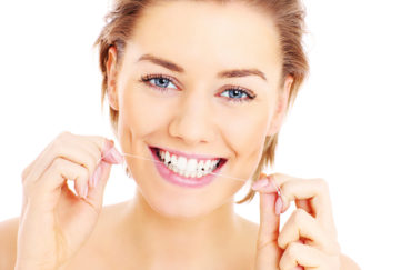 A picture of beautiful womanusing a floss for her teeth