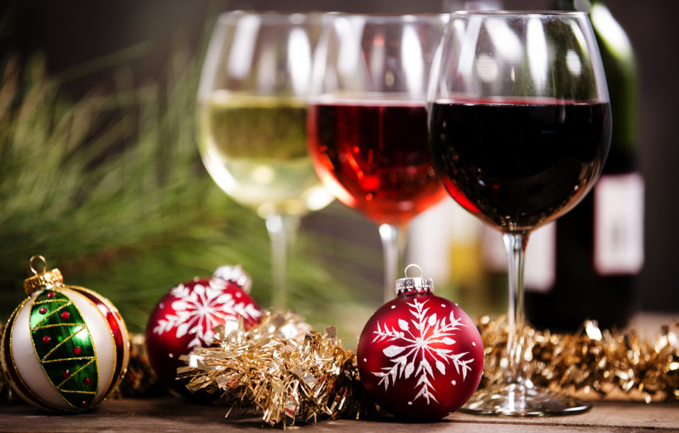 A glass of white, rose and red on a Christmas table with baubles Pic: Istockphoto