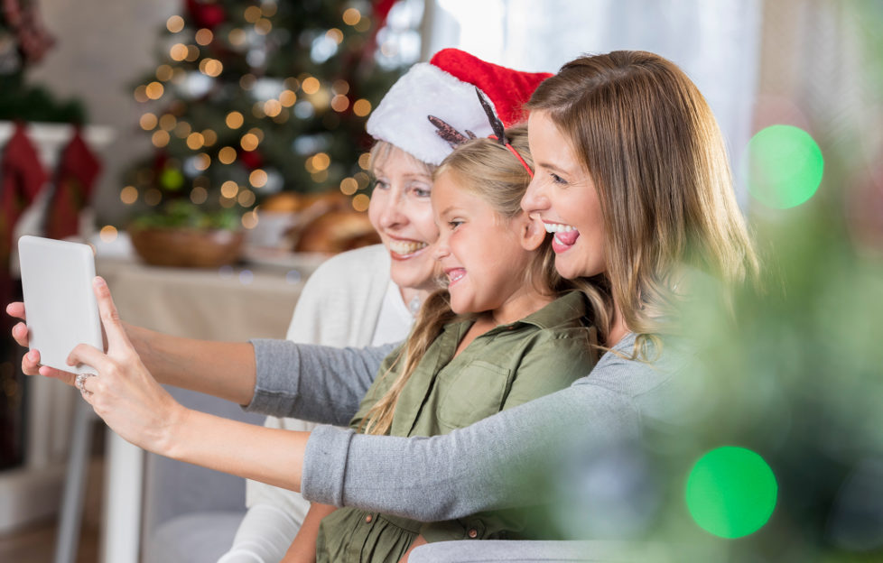 Little girl poses for selfie with mom and grandma