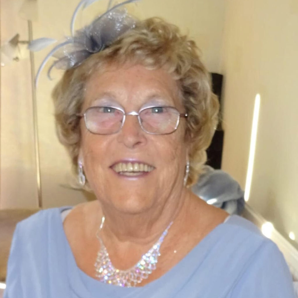 Smiling mature lady in wedding outfit (soft blue dress)