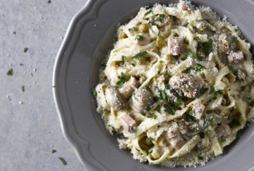 Bowl of tagliatelle pasta with creamy mushroom, bacon and parsley sauce