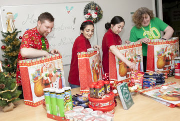 Royal Voluntary Service volunteers in Staffordshire package up Christmas hampers to deliver to older people in the community