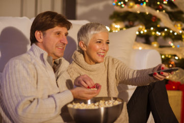 Mature couple watching TV for Christmas