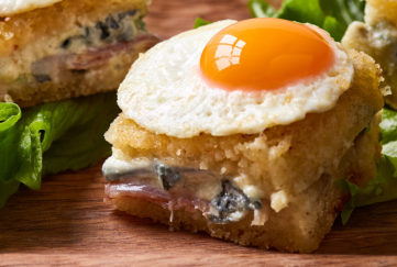 Close up of mini croque madame with fried quail's egg on top