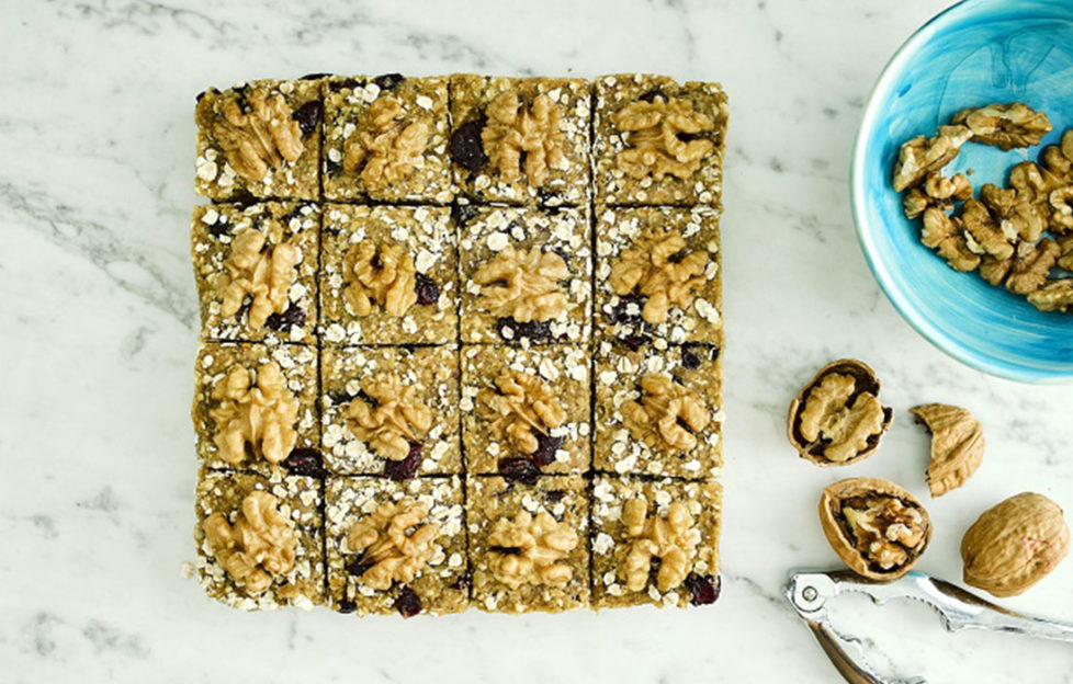 Block of raw flapjack, cut into 16, topped with walnuts