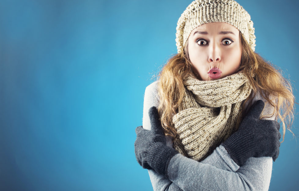 Young woman with scarf beret and glove shivering