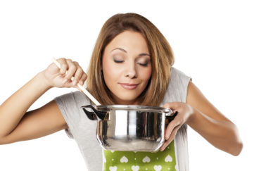 Woman enjoying the smell of food from the pot Pic: Istockphoto