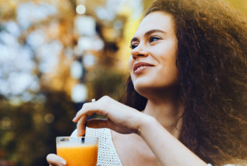 Young woman drinking orange juice
