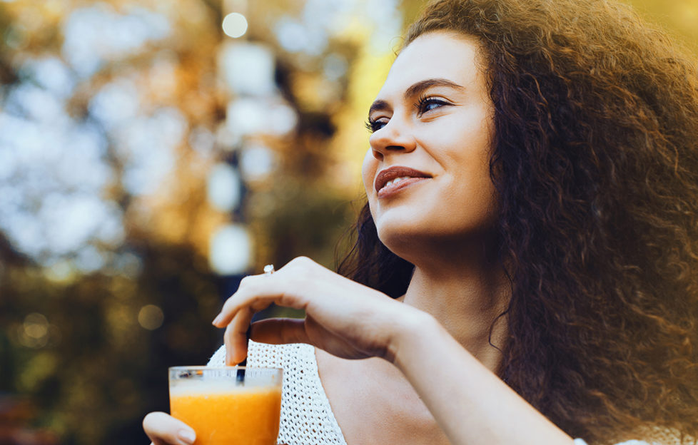 Young woman drinking orange juice