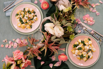 Pasta meal for two with flowers on table