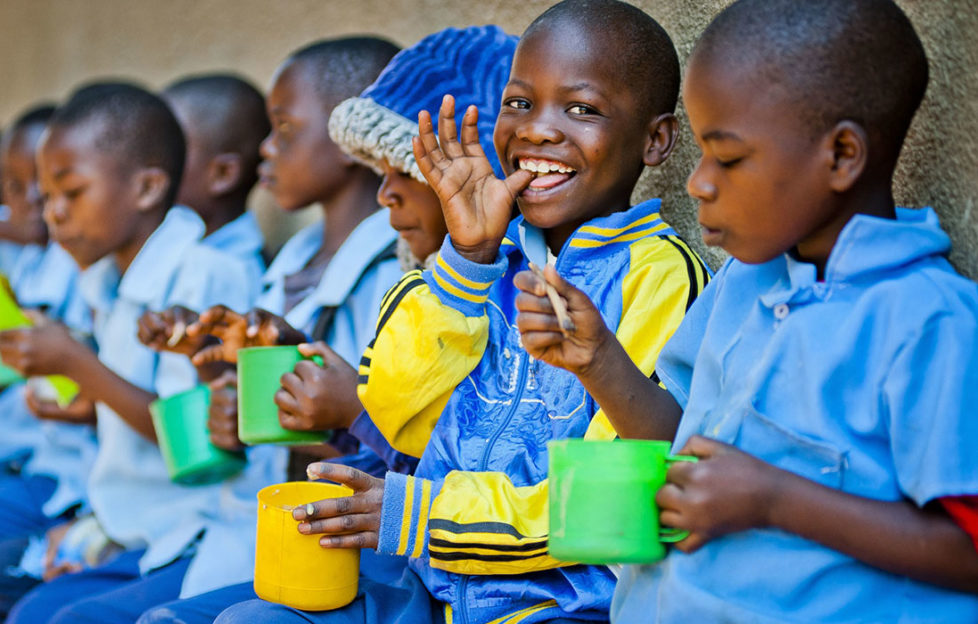 Children enjoying food from the Mary's Meals school feeding campaign Pic: Chris Watt