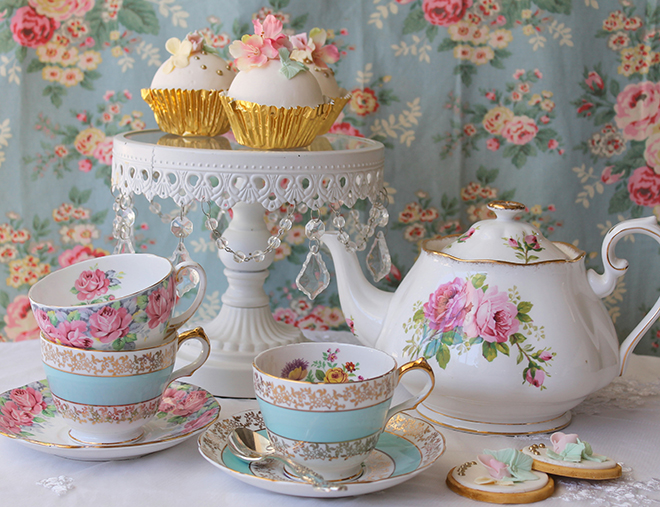 Vintage tea cup and saucer, pink roses teapot and cupcakes on white cake stand Pic: Istockphoto
