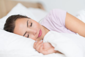 Portrait of a beautiful woman sleeping in bed and looking very peaceful