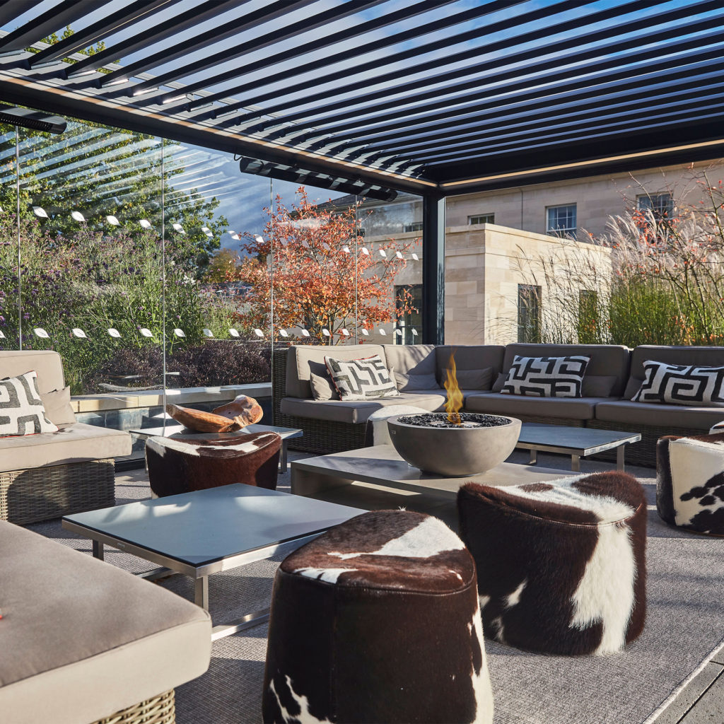 Rooftop cabana at Rudding Hall with sofas and low tables, plus automatic slatted roof