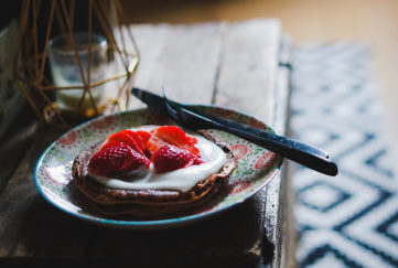 Chocolate pancake topped with yoghurt and stawberries