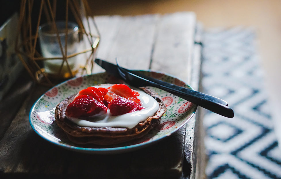 Chocolate pancake topped with yoghurt and stawberries