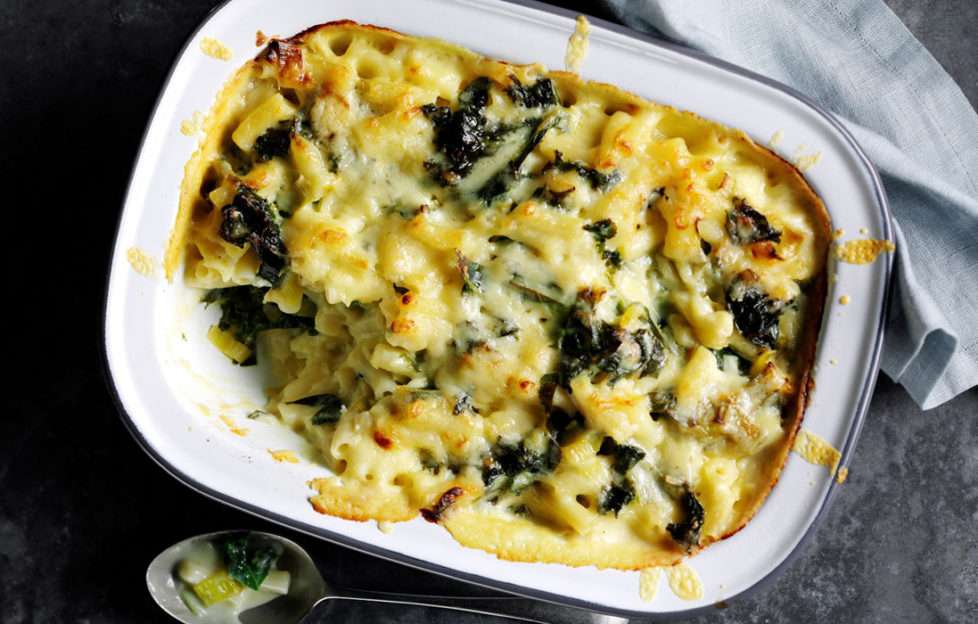 Oval dish of baked macaroni cheese with kale