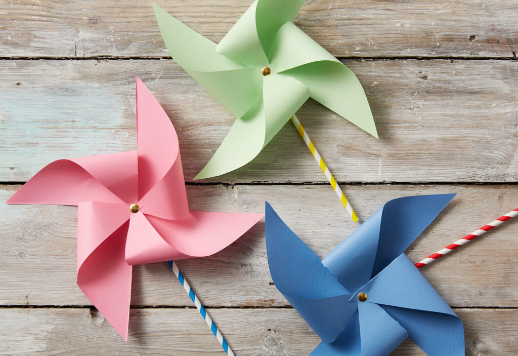 Three finished pinwheels - mini windmills - in pink, green and blue