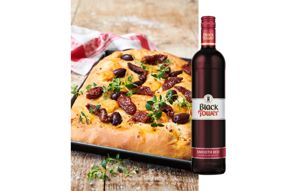 Focaccia bread and a bottle of Black Tower Smooth Red wine