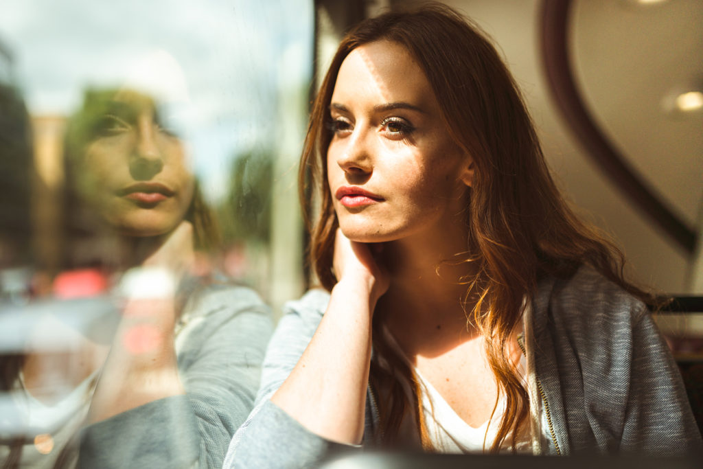 Woman sitting on bus looking out window