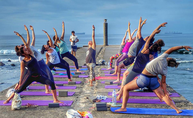 Yoga on a pier at the sea