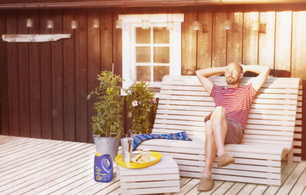 Man sitting on white bench in garden