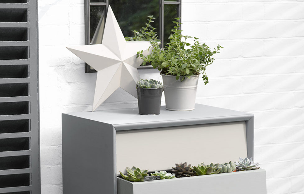 Chest of drawers painted in shades of grey and white