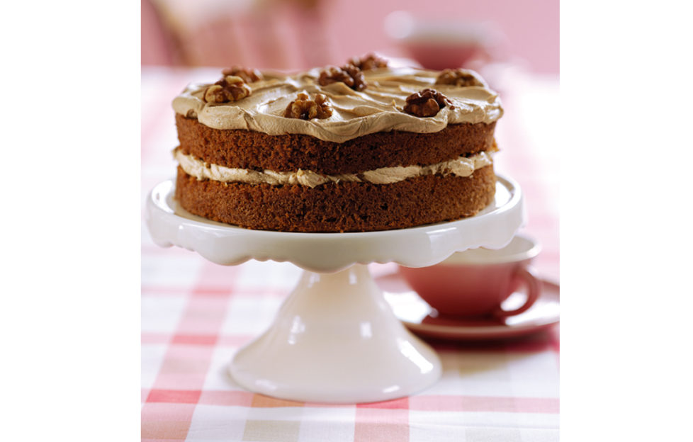 Coffee and walnut cake on a cake stand