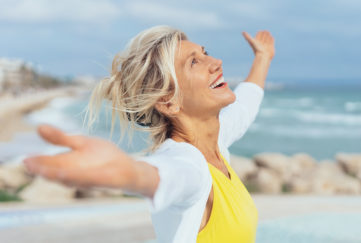 Joyful woman enjoying the freedom of the beach Pic: Istockphoto