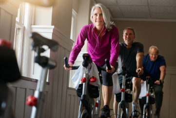 Shot of a group of seniors having a exercising class at the gym - spin class