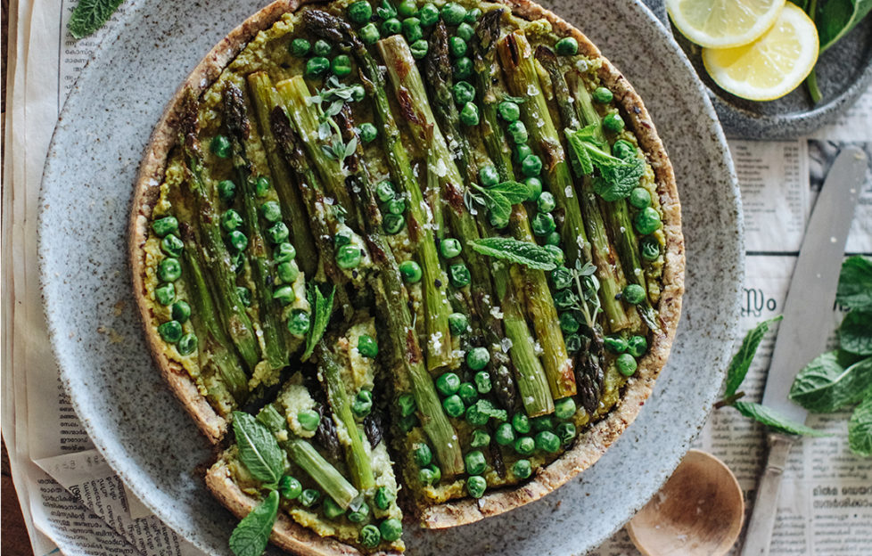 Asparagus, pea and mint tart, wholemeal nutty pastry crust, slices of lemon on the side, one slice cut