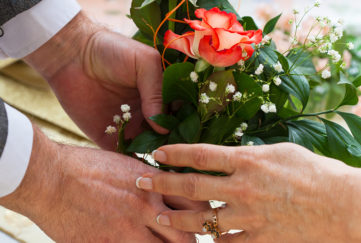 Older man giving a bouquet of roses to a woman Pic: Istockphoto