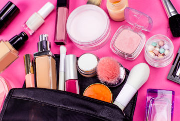 Make-up and brushes spilling out of a cosmetics bag
