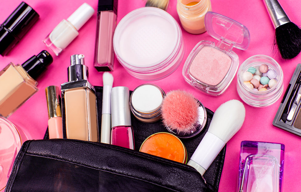 Make-up and brushes spilling out of a cosmetics bag