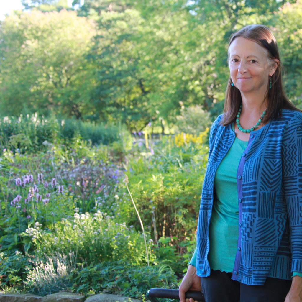 Gardening expert Susie White stands in front of a shady part of her garden