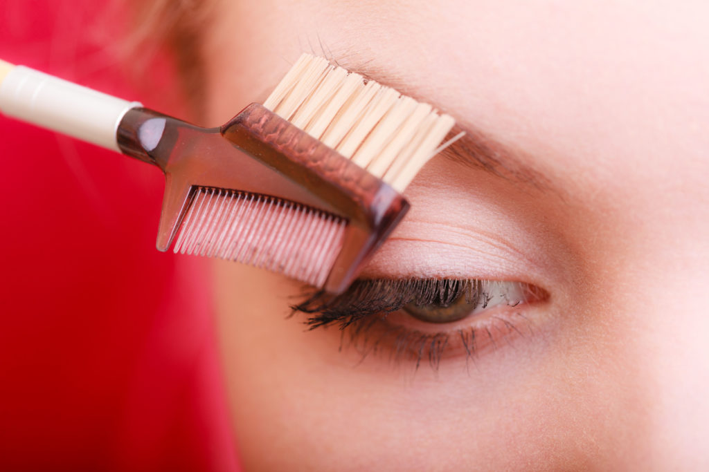 Closeup of woman using brush to give brows shape Pic: Istockphoto