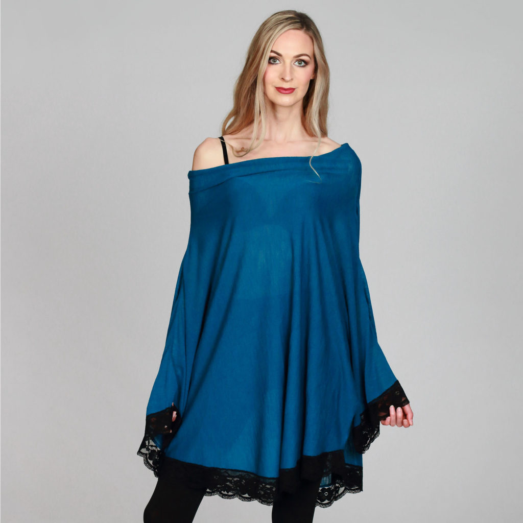 Model in deep blue satin tunic dress, off the shoulder, long sleeves, cuffs and hem trimmed with deep band of black lace