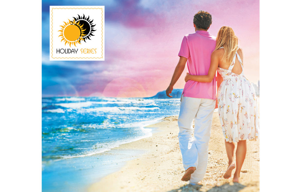 Young couple walking on beach at sunset, heightened colours