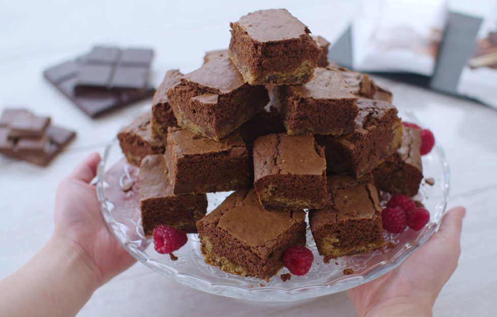 Pyramid of cut squares of two-layered chocolate brownie