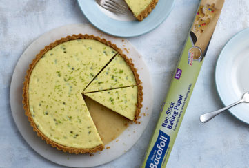 Golden yellow key lime pie with lime zest, three slices cut