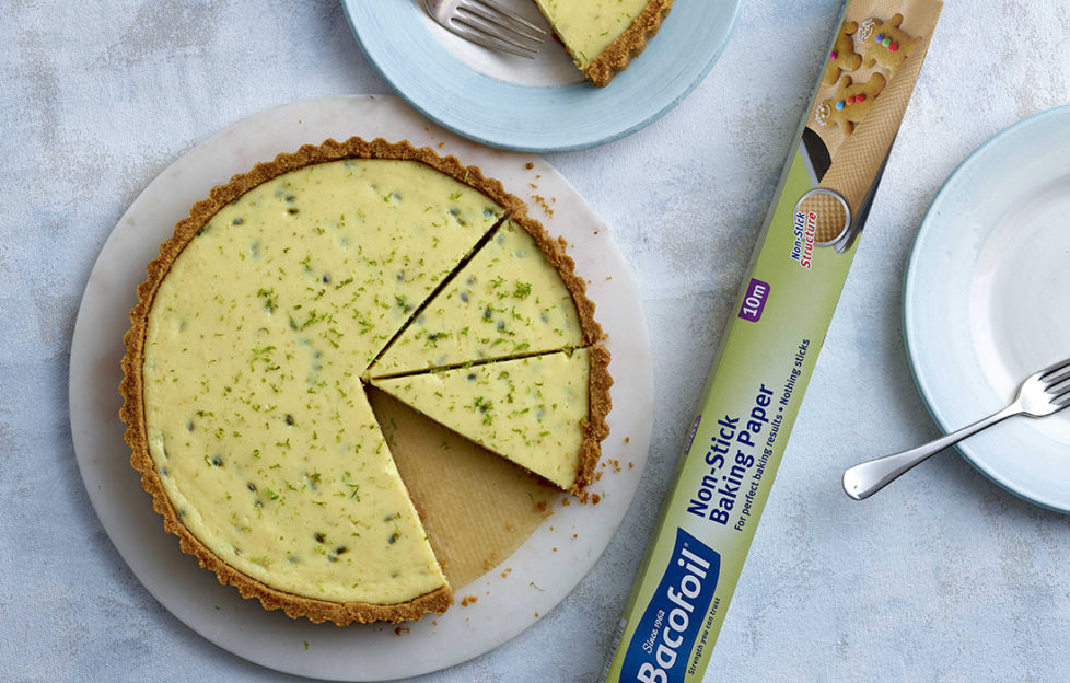 Golden yellow key lime pie with lime zest, three slices cut