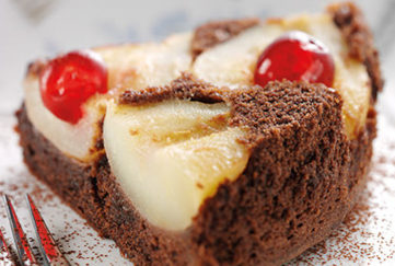 Chocolate and pear upside-down cake with glace cherries