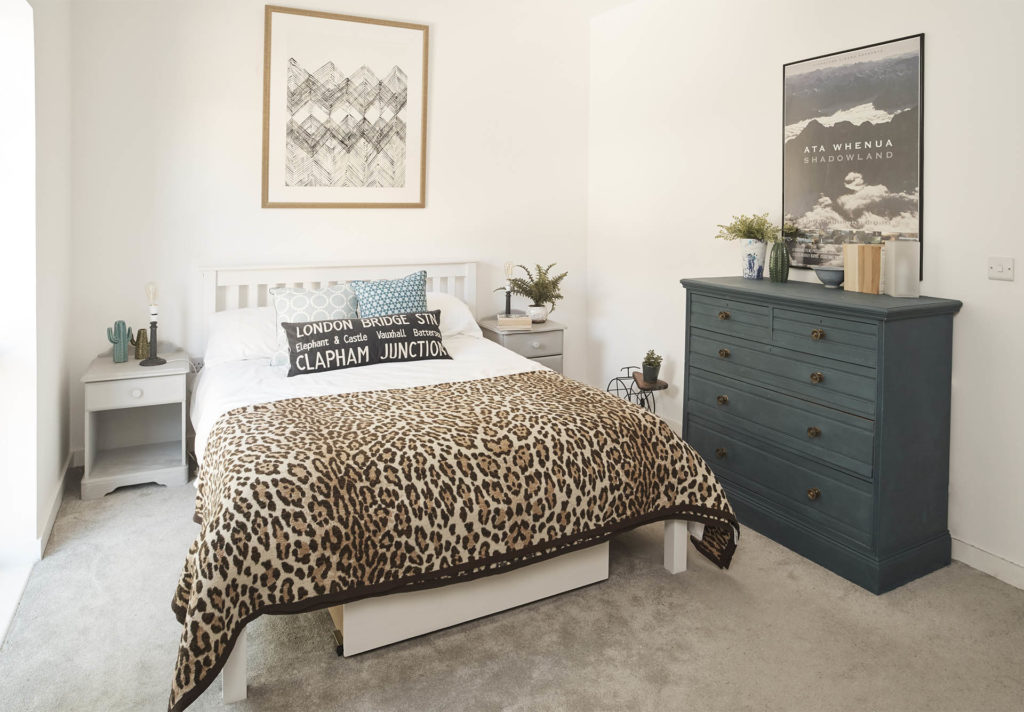 Room is neat and brighter with 1 large chest of drawers painted rich dark green and under-bed storage