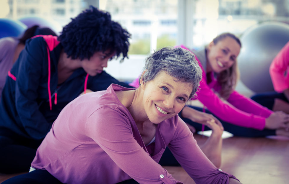 Happy women exercising in fitness studio