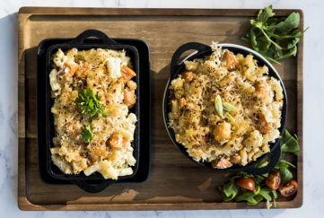 Two dishes of macaroni with cubes of pumpkin, topped with breadcrumbs and cheese